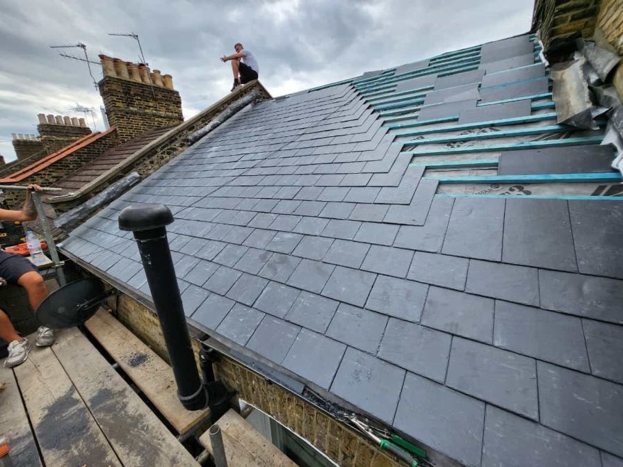 Professional roofers installing slate roof replacement on home in Kildare Ireland